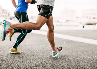 Couple runs outside on pavement
