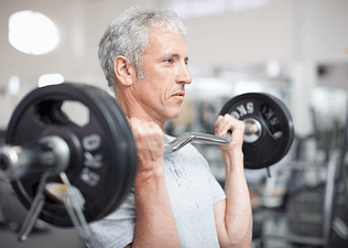 Man lifts a barbell at gym