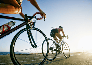 Two people ride bikes in an outdoor race