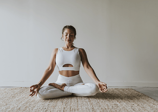 Woman practices Lotus Pose 