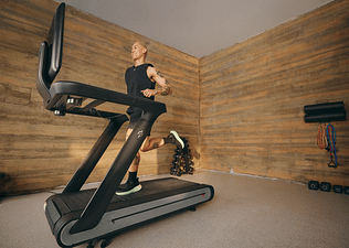 Man running on a Peloton Tread+ wondering about the differences between running on a treadmill vs outside.