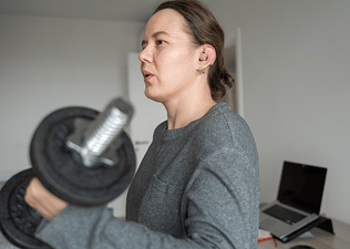 Woman does a bicep curl exercise with dumbbell