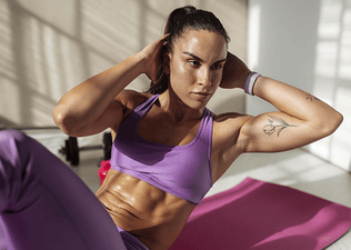 Woman doing oblique crunches during a home ab workout