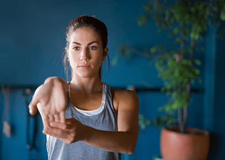 Woman performs a wrist stretch 