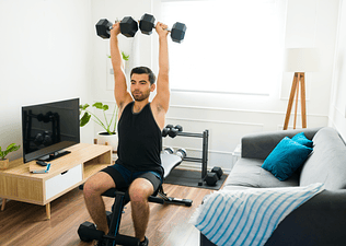 Man lifts weights at home