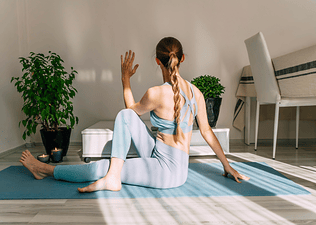 Woman performs a yoga twist pose