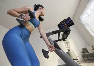 Woman training with Peloton wearing an integrated wearable