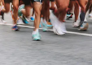 Blurry shot of people's feet while running a marathon.