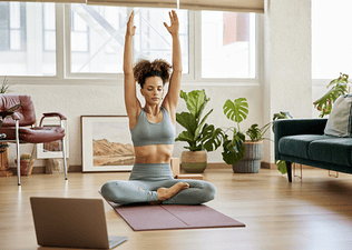 Woman stretches at home