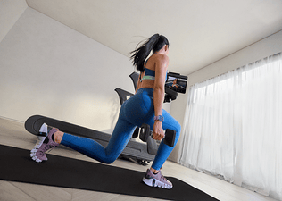 Woman doing a cross training workout for runners with dumbbells using a Peloton Cross Training Series treadmill.