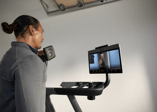 Man doing a Peloton strength benchmarks workout at home with his Peloton Tread+.