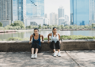Two women exercise outdoors