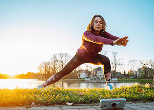 Woman does a lunge exercise outdoors