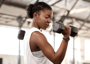 Woman lifts weights at gym