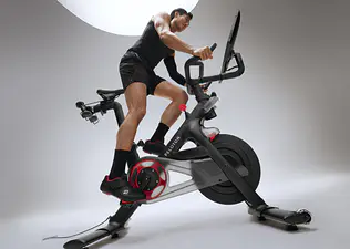 Man doing an FTP cycling test on a Peloton bike.