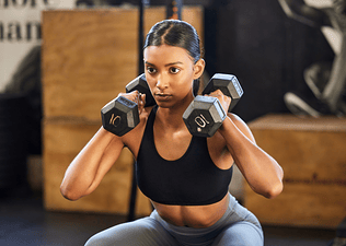 Woman lifting weights at gym