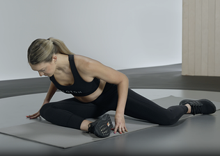 Woman practices the 90/90 hip stretch