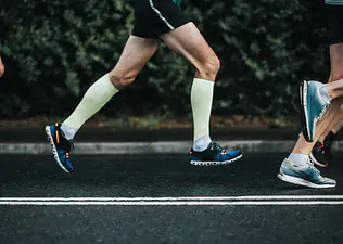 Runners' legs on a road training to improve running economy