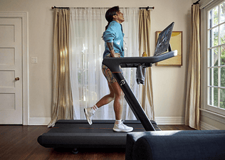 Woman walking on a Peloton Tread