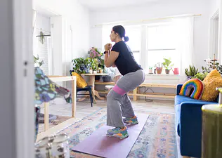 Woman does a resistance band exercise at home