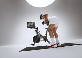 Woman doing a strength workout on the Peloton Cross Training Bike+ Powered by Peloton IQ. 