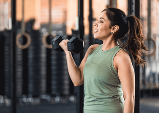 Woman lifts weight at gym