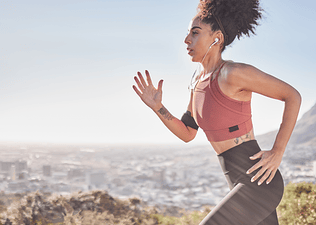 Woman running outdoors wearing headphones