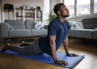 Man doing at-home yoga for his lower back.