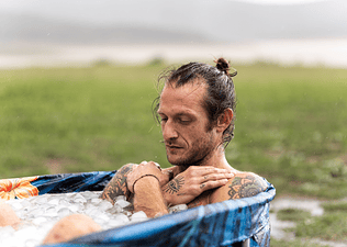 A man in an ice bath after a workout.