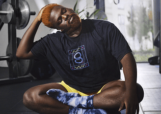 Peloton member stretching to warm up, reducing muscle cramps