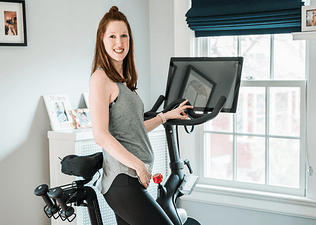 Woman on Peloton Bike Pregnant