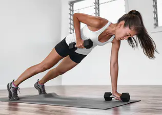 Woman does a plank row exercise at home