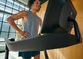 Man running on Peloton treadmill
