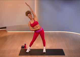 Ally Love demonstrates an ab stretch in a Peloton class