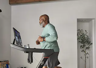 Man runs on a Peloton Tread