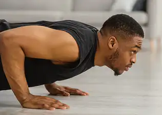 A close-up photo of a man doing a push-up.