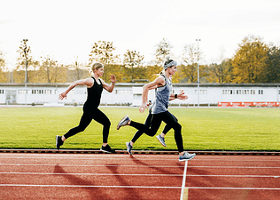Three women running on a track