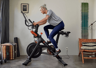 Woman riding a Peloton Bike