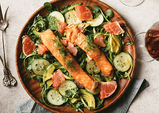 An aerial view of a healthy watercress salad with salmon.