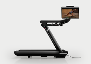 the Peloton Tread Vision treadmill with the screen swiveled to show a yoga class