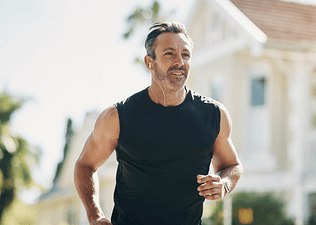 A man going for a run outdoors on a sunny day, using his rate of perceived exertion (RPE) to gauge his effort.