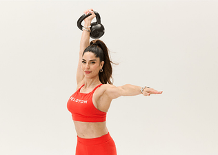 Peloton instructor Assal Arian holding a kettlebell above her head