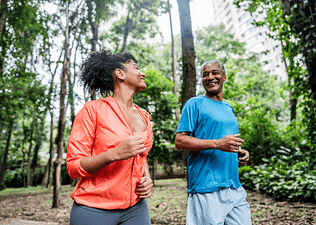 A father and daughter going for a walk outdoors to ease lower back pain.
