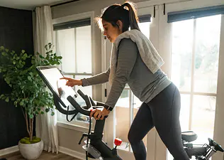 Woman on Peloton Bike looks at screen 