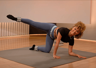 Peloton instructor Ally Love wears ankle weights during a Peloton barre class