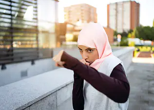 Woman boxes outside, showcases the benefits of boxing