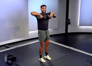Peloton instructor Rad Lopez demonstrating a dumbbell upright row with proper form