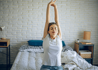 Woman stretching on bed