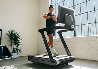 Man walks on a Peloton Tread