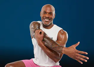 Peloton instructor Adrian Williams stretching for the Peloton x Hospital for Special Surgery shoulder rehab program